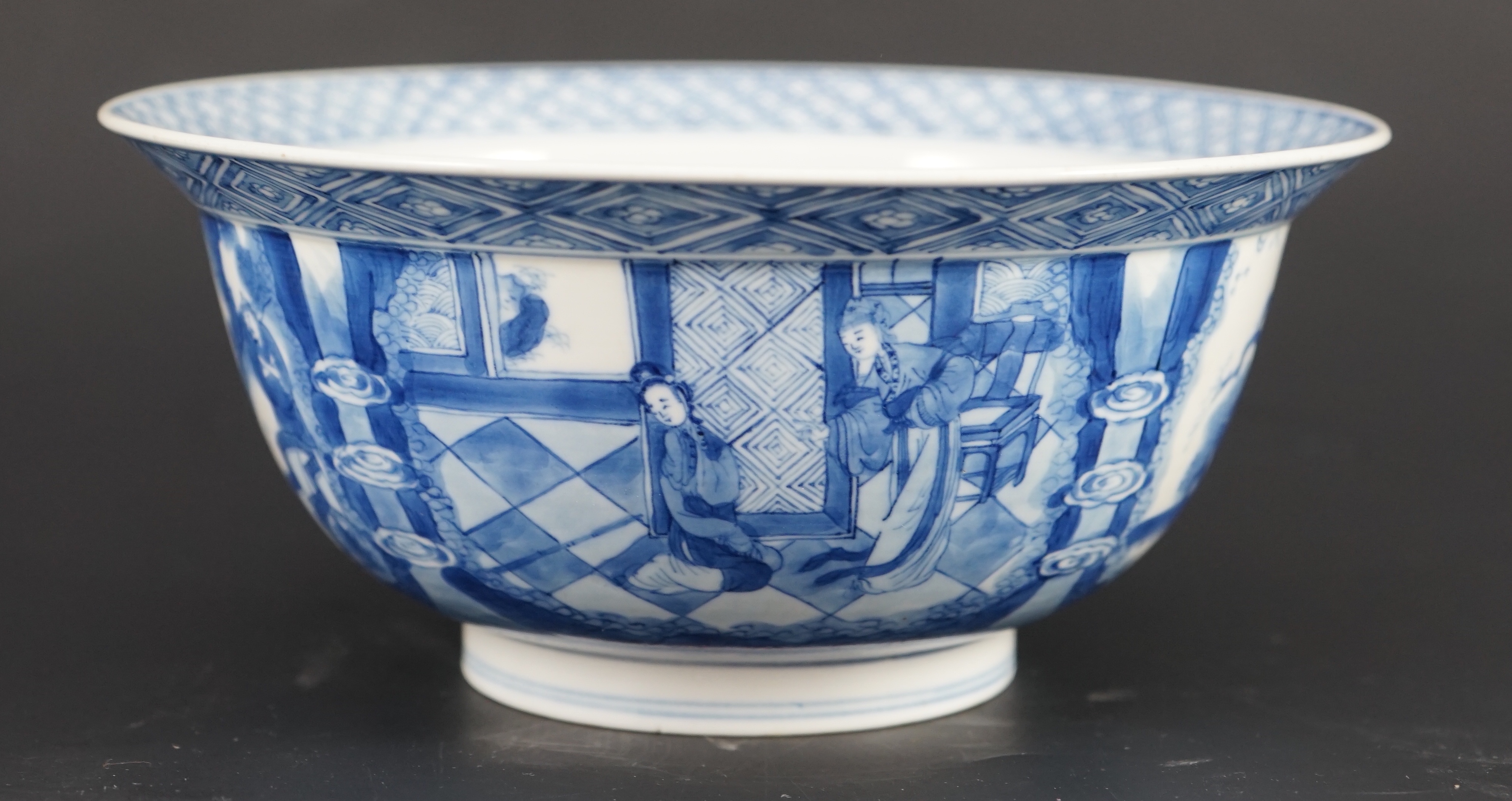 A fine Chinese blue and white ‘Xi Xiang Ji’ bowl, Kangxi six character mark and of the period (1662-1722) 19.9cm diameter, wood stand